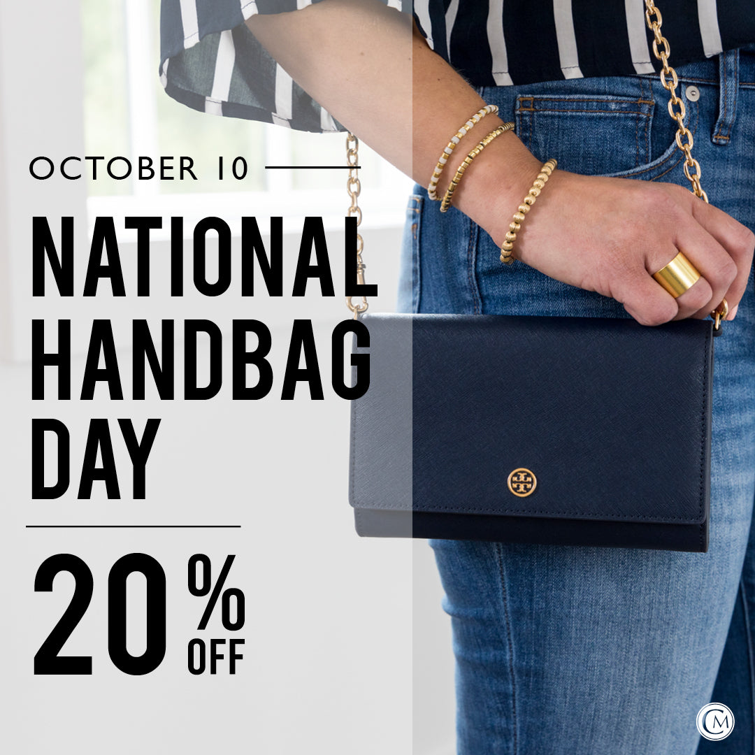Promotional graphic for National Handbag Day with a hand holding a black handbag, text overlay, and a blurred background.